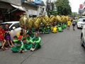 Group of people carrying a large dragon take a break during the parade of a Festival of the Clans of the Chinese community of Bang