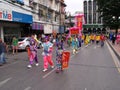 Many people in the parade in a Festival of the Clans of the Chinese community of Bangkok