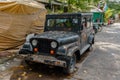 Old green army style Jeep parked on the roadside in Bangkok, Thailand Royalty Free Stock Photo