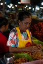 Bangkok, Thailand - November 2, 2019: Older Asian woman working at a street market