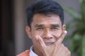 Positive portrait of a thai man who works as a motorbike taxi driver on the streets of Bangkok, Thailand