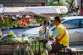 BANGKOK, THAILAND - NOVEMBER 2018: Salesman is riding on his bike with vegetables and fruits in Bangkok, Thailand