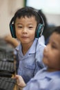 Young school kids start learning how to use a computer.