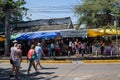Bangkok, Thailand - November 30, 2019: Shoppers cross the street to enter the famous Chatuchak Weekend Market to visit all of the