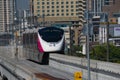 The Pink Line electric train running on train track