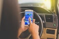 BANGKOK, THAILAND - NOVEMBER 12th, 2017 : Hand of woman using mobile phone with icons of social media on screen in the car Royalty Free Stock Photo