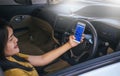 BANGKOK, THAILAND - NOVEMBER 12th, 2017 : Hand of woman using mobile phone with icons of social media on screen in the car Royalty Free Stock Photo