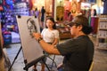 BANGKOK, THAILAND - November 14, 2016: Unidentified artist drawing pencil portrait of the tourist at ASIATIQUE The Riverfront