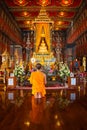 Unidentified Buddhist monk pays respect to the Buddha Sihing statue inside the Phutthai Sawan Throne Hall at Bangkok