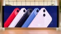 Apple iPhone 13 smartphone new release in multiple colors, advertisement on ads display screen in shopping mall