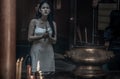 Beauty young woman in white dress Hold incense pray homage to buddha`s blessing Within the Chinese shrine Royalty Free Stock Photo