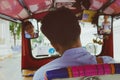 BANGKOK, THAILAND - OCT 13, 2015 Editorial Use Only / Asian man, driver tuk tuk looks in the rearview mirror / Journey backpacker Royalty Free Stock Photo