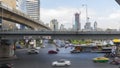 Street traffic at Intersection of Silom Road and Rama IV Road with Thai-Japanese Friendship Bridge in Bangkok, Thailand