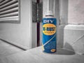 BANGKOK, THAILAND - OCTOBER 13, 2020: Can of Mr. DIY De-Rust Lubricant Spray next to a Rusty Door Hinge