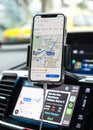 Google Maps app with Apple CarPlay on car screen dashboard and iPhone, smart UI mobile application for travel navigation