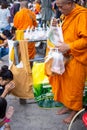 Thai monk ask for alms for buddhist to make merit Royalty Free Stock Photo