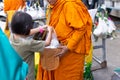 Thai monk ask for alms for buddhist to make merit Royalty Free Stock Photo