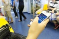 Bangkok, Thailand - 15 October 2014 : Unidentified woman is using mobile phone on the sky train.