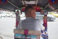 Bangkok, Thailand - October 2017: View from inside a Tuk Tuk in busy streets of Bangkok with young Thai driver.