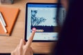 Bangkok, Thailand - October 25, 2019 : woman hand holding and is pressing the Facebook screen on apple digital tablet. Royalty Free Stock Photo