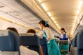 BANGKOK, THAILAND - Sep 27, 2018 - Bangkok Airways flight attendant serve food and drinks to passengers on board. Royalty Free Stock Photo