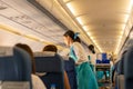 BANGKOK, THAILAND - Sep 27, 2018 - Bangkok Airways flight attendant serve food and drinks to passengers on board. Royalty Free Stock Photo