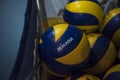 Bangkok, Thailand - Sep 25, 2019 - Closeup of Mikasa Volleyballs in a movable sport cart storage in an indoor school gym.