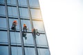 Group of workers cleaning windows service on high rise building - High building and Risk working Royalty Free Stock Photo