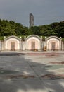 Three Traditional chinese graves are at Chinese cemetery are against the modern building and sky background Royalty Free Stock Photo