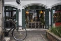 Bangkok, Thailand- 30 Sep 2020: vintage and rustic of white building old green folding wood door with old classic bicycle at front