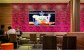 BANGKOK, THAILAND - SEPTEMBER 07: Flat panel display shows Mcdonald`s TV commercial inside Mcdonald`s fast food restaurant in Royalty Free Stock Photo