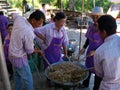 Four people prepare a dessert at the Taling Chan Floating Market in Bangkok