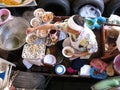 A man cooks in his boat at the Taling Chan Floating Market in Bangkok