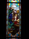 One of the artistic and colorful stained glass windows with images of the Bible in the Assumption Cathedral. Bangkok