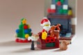 Bangkok, Thailand. September 2,2023 - Santa Claus Lego minifigure and cat sitting near fireplace. Studio shot