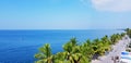 Top view of road with car and people beside the beautiful sea, coconut or palm tree with clear blue sky Royalty Free Stock Photo