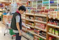 BANGKOK, THAILAND - SEPTEMBER 22: Unnamed employee routinely checks inventory on the shelves in Foodland Supermarket in Bangkok on