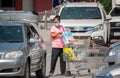 BANGKOK, THAILAND - SEPTEMBER 10: Unnamed woman loads grocery from shopping cart to the car in parking lot of Macro wholesale