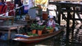 A woman cooking in a boat at Taling Chan Floating Market in Bangkok