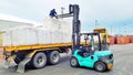 Bangkok, Thailand-16 September 2017: Workers unload jumbo bags from trailer to wooden pellet at LCB container yard