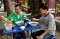 Bangkok, Thailand: Thai Men Eating at Sidewalk Restaurant