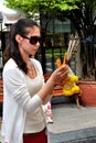 Bangkok, Thailand: Woman Praying at Erawan Shrine