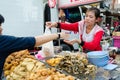 Bangkok, Thailand: Woman selling food