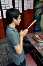 Bangkok, Thailand: Young Man at Prayer Royalty Free Stock Photo