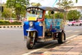 Bangkok Tuk-tuk taxi tricycle stands on the side of the road. Royalty Free Stock Photo