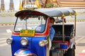 Bangkok Tuk-tuk taxi tricycle stands on the side of the road. Royalty Free Stock Photo