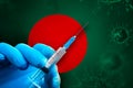 Bangladesh Covid-19 Vaccination Campaign. Hand in a blue rubber glove holds a syringe with covid-19 virus vaccine Royalty Free Stock Photo