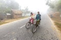 Bangladesh Ã¢â¬â January 06, 2014: On a foggy winter morning, two young girls are going to school by riding bicycle. at Ranisankail