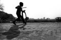A restless boy is playing on the village road with old discarded tires at Savar, Dhaka,