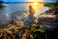 A worker cleans decomposing jute-fibers on the river water in the evening time at Rajrajeshor, Royalty Free Stock Photo